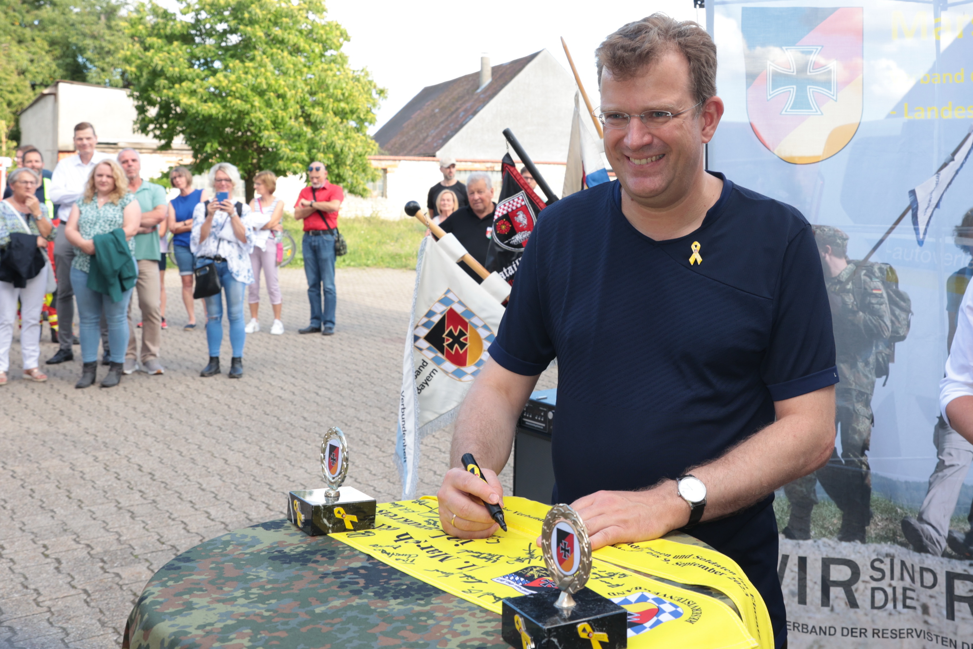 MdB Dr. Reinhard Brandl unterschreibt auf dem gelben Band